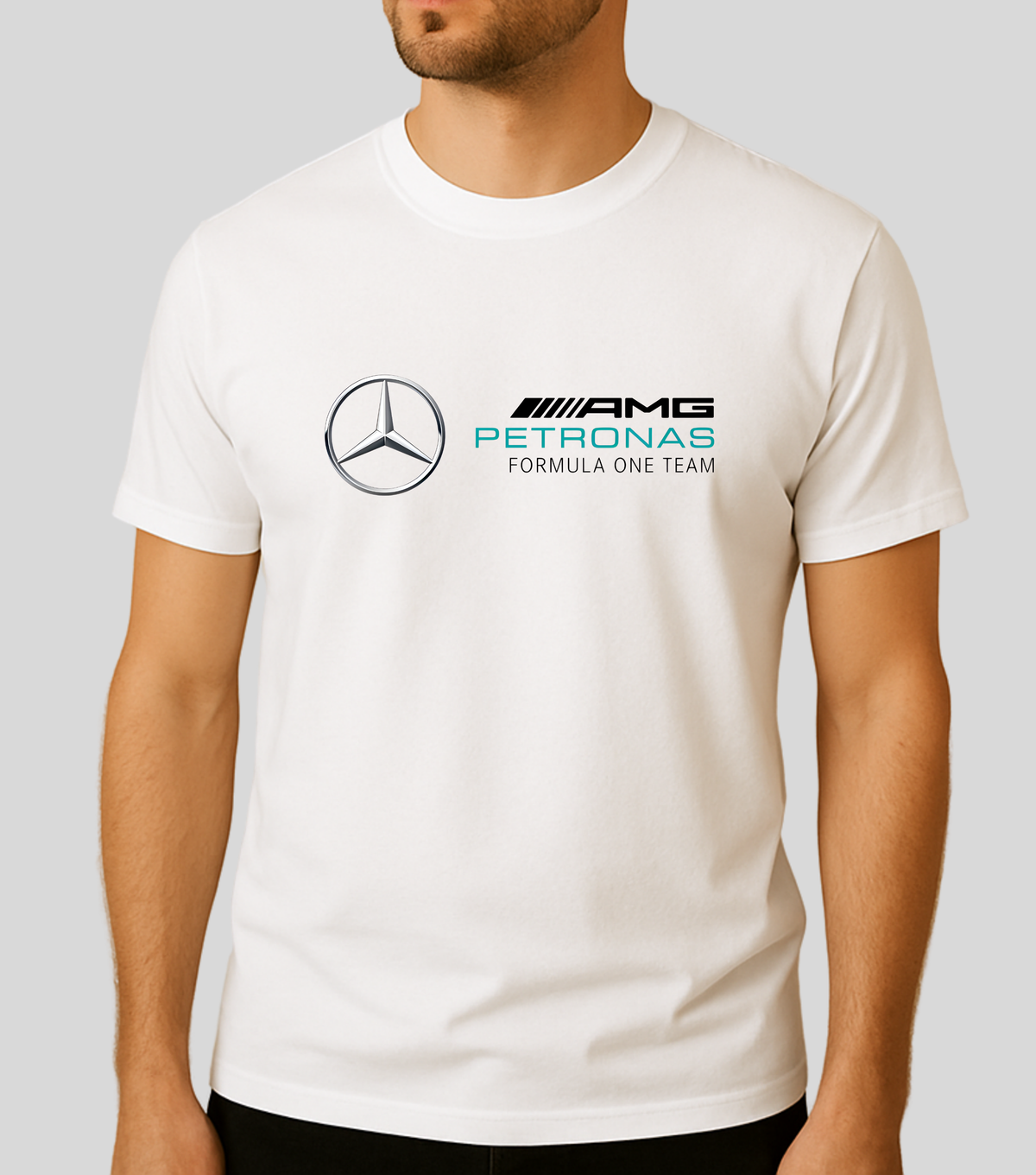 A man wearing a white crewneck t-shirt featuring the Mercedes-Benz logo and the AMG Petronas Formula One Team logo printed on the chest, set against a plain light gray background.